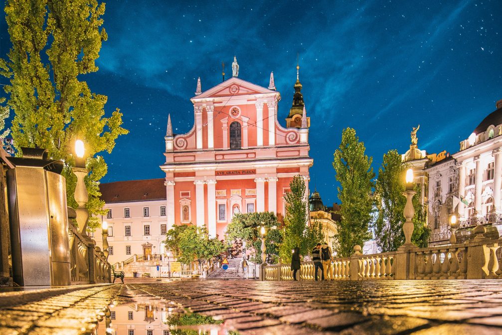 The pink Franciscan Church of the Annunciation in Ljubljana at night