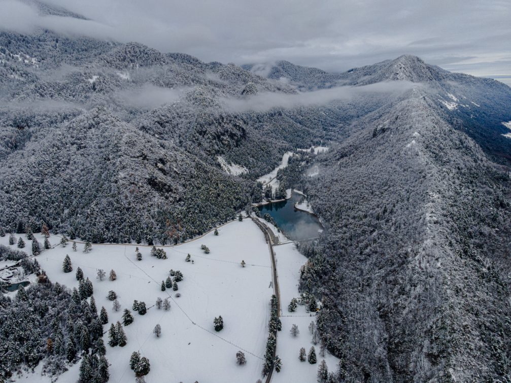 Aerial view of the snow-covered Zavrsnica Valley in winter with Lake Zavrsnica in the middle
