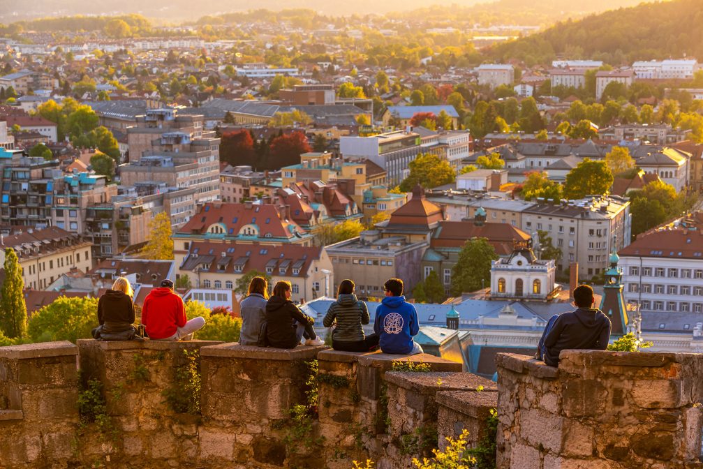Visitors enjoying views of Slovenia's capital from Ljubljana Castle at sunset