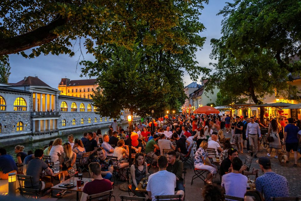Outdoor cafes packed with people in Ljubljana Old Town in the evening