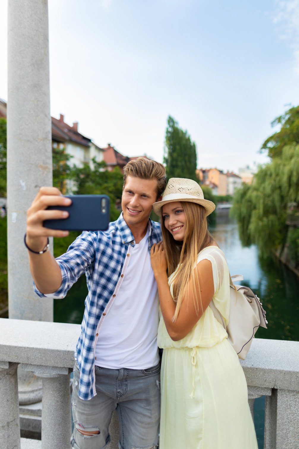 A couple making a selfie on the bridge in Ljubljana Old Town