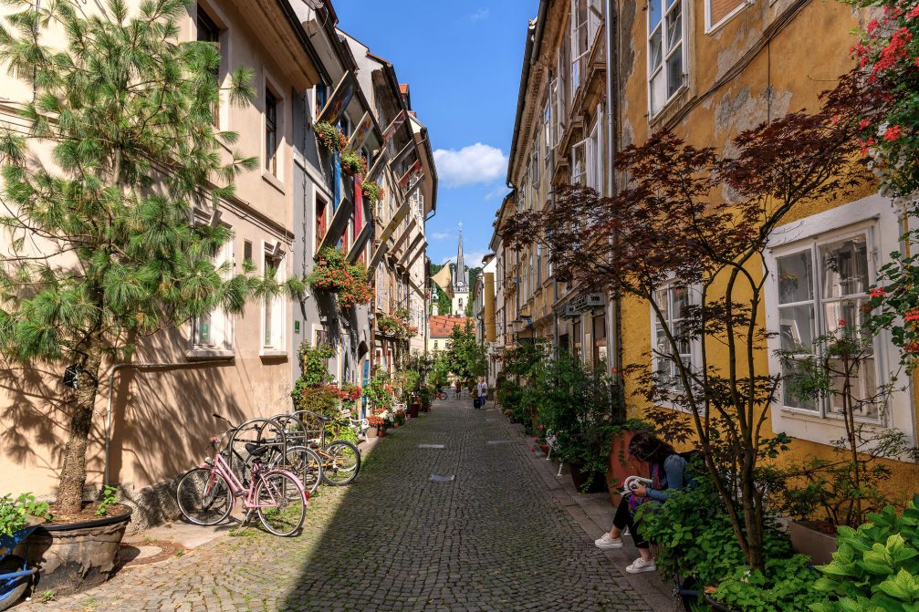 A street with many green plants in Ljubljana Old Town in summer
