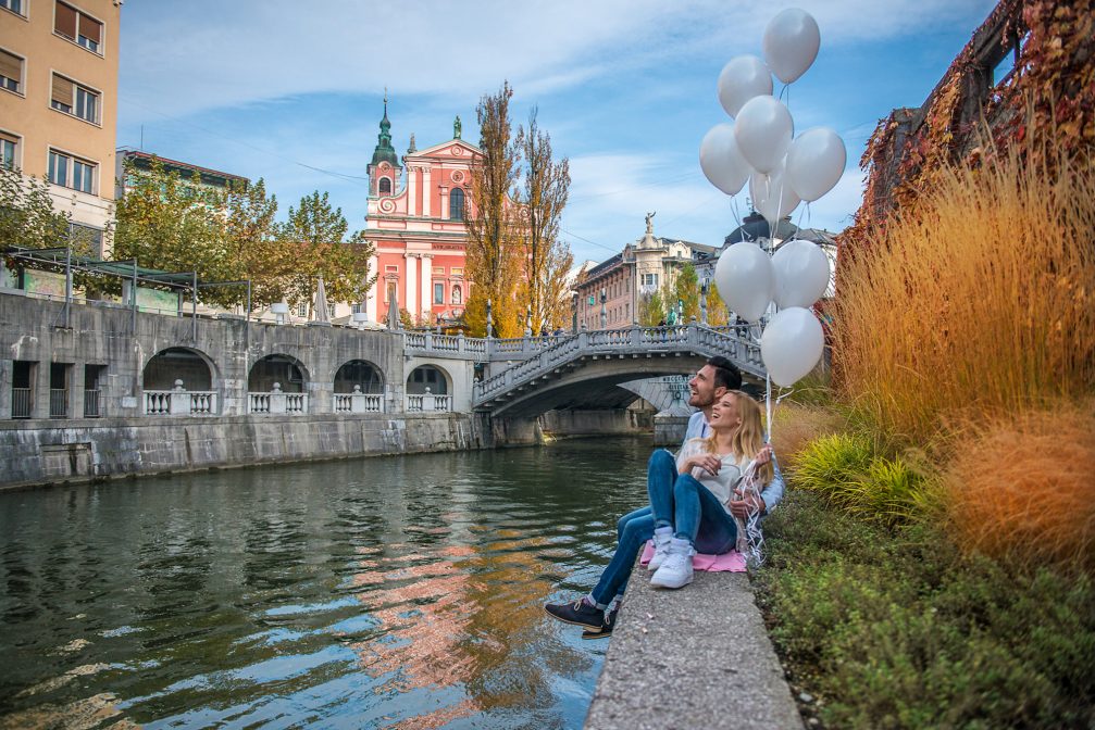 Ljubljanica River Canal in Ljubljana Old Town with Triple Bridge in the background