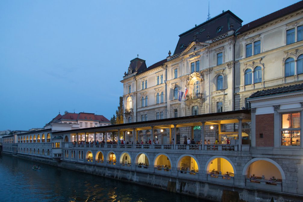 Plecnik Covered Market alongside River Ljubljanica in Ljubljana in the evening