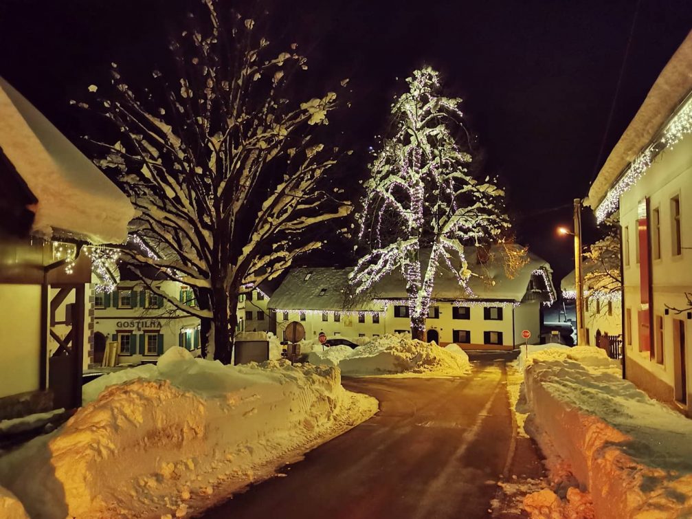 Village of Podkoren covered in snow at night in the holiday season