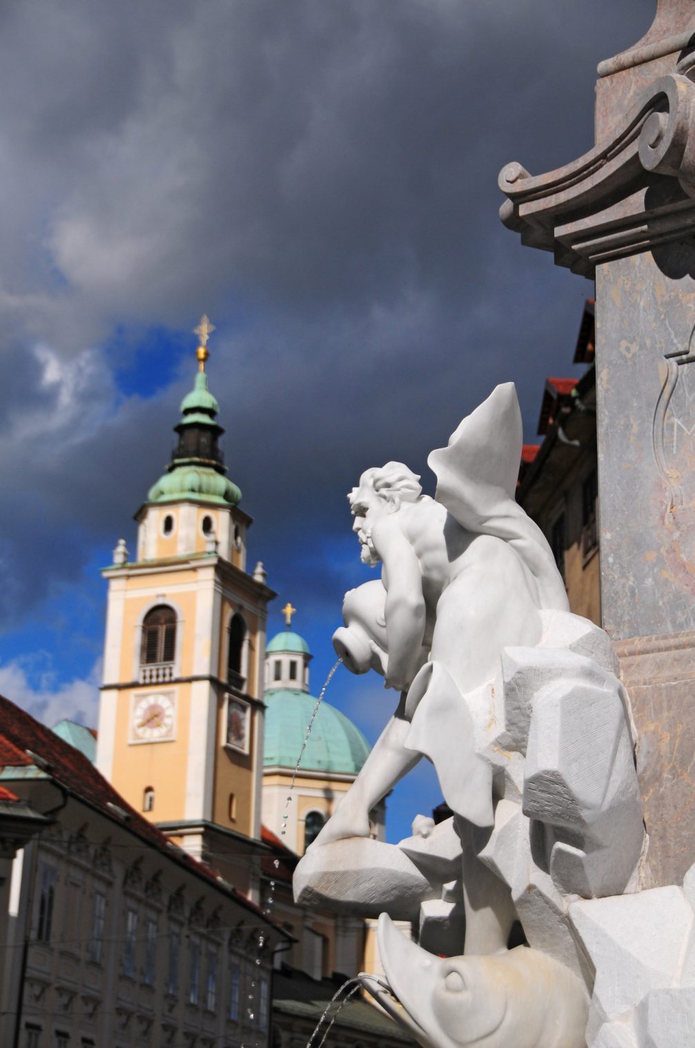 A detail of Robba Fountain with Ljubljana Cathedral in the background