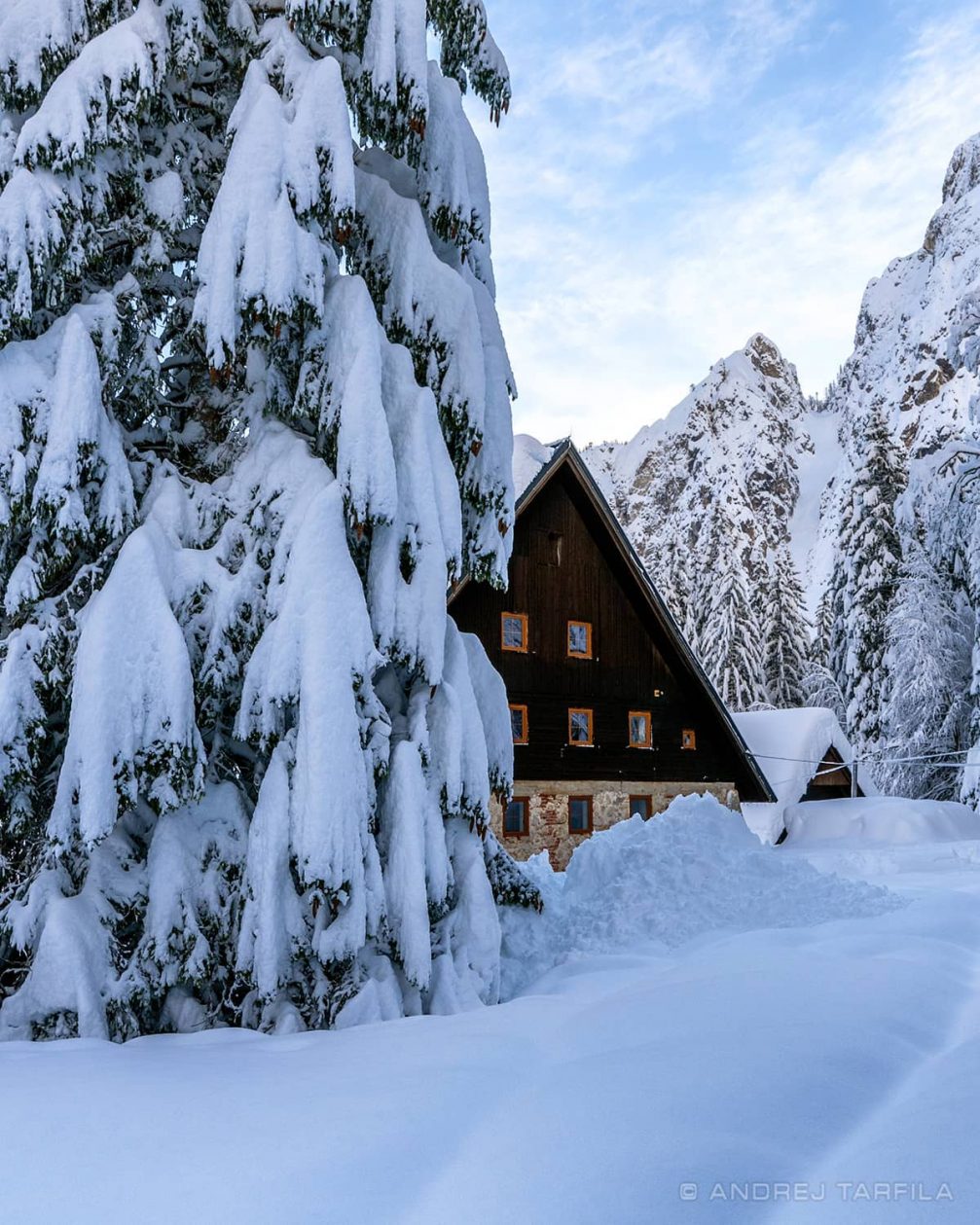 A mountain cottage covered in snow in Tamar Valley in Slovenia