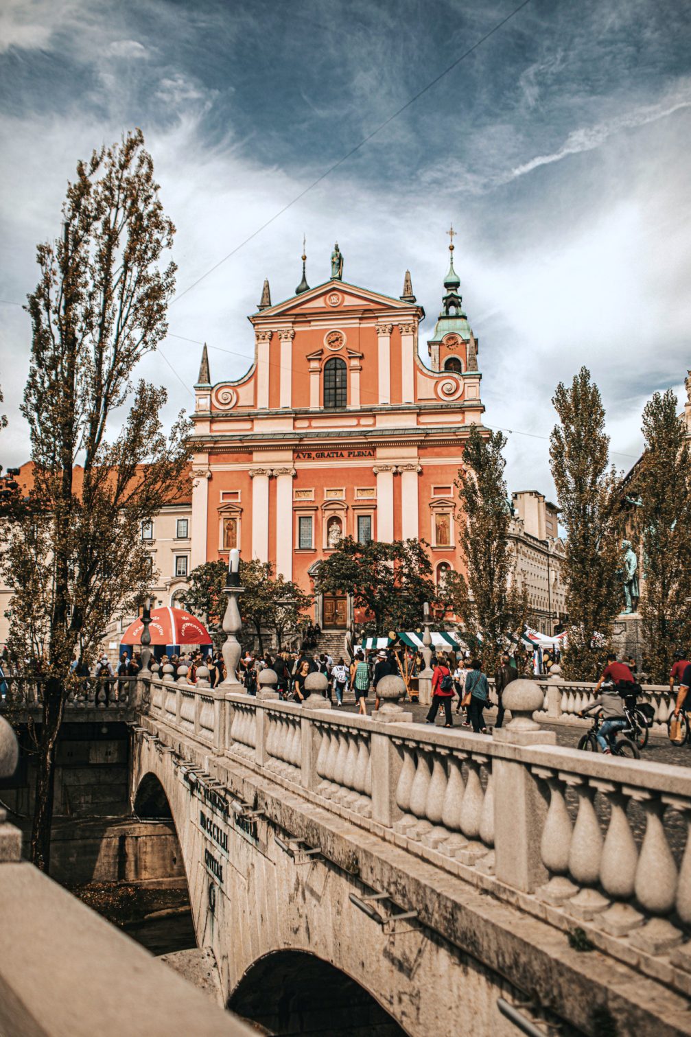 Triple Bridge in Ljubljana with the salmon pink Franciscan Church in the background