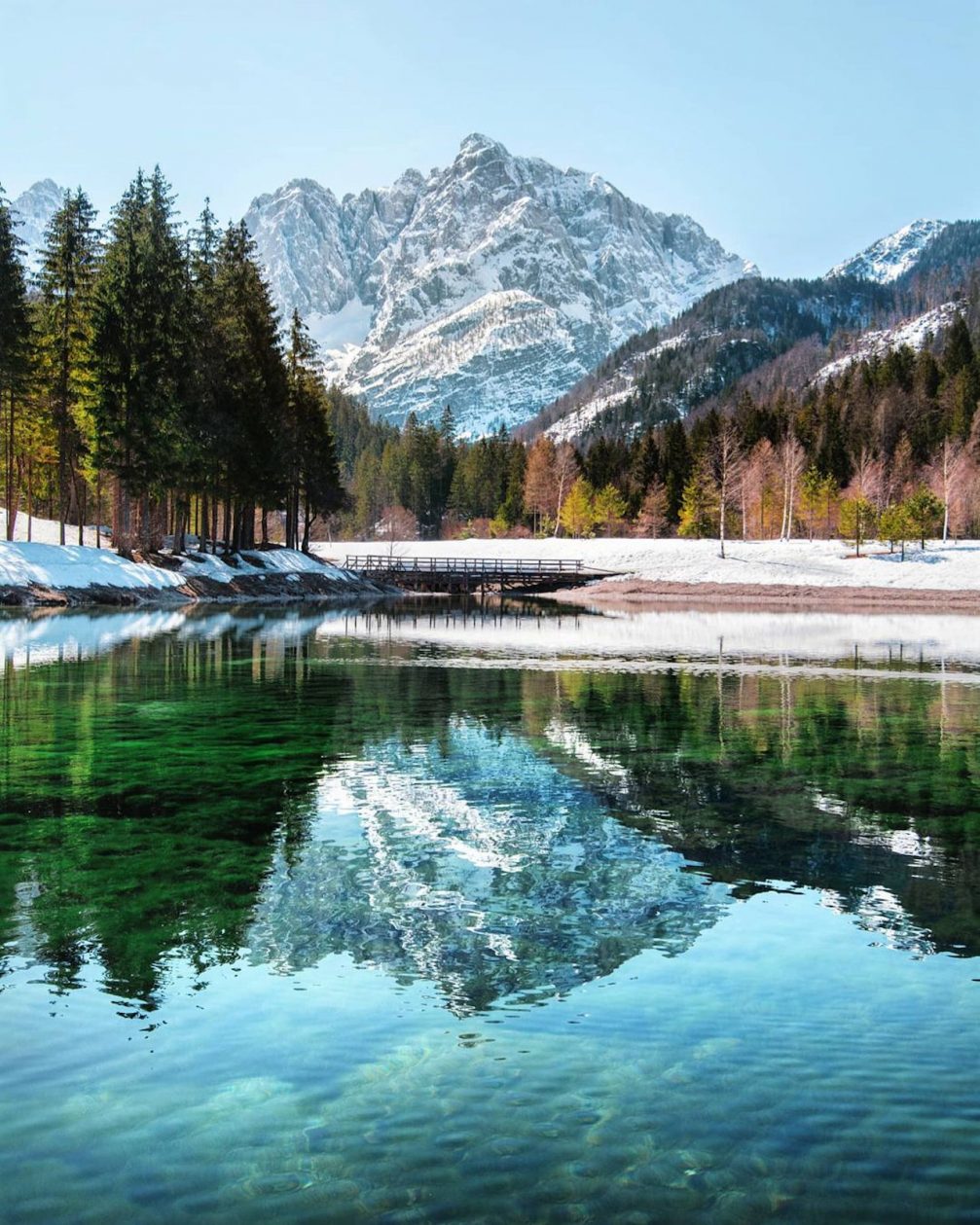 Lake Jasna in Kranjska Gora in early spring with melting snow around