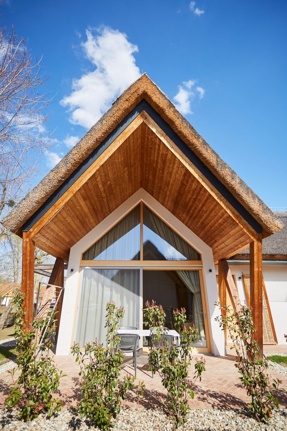 A wooden house inspired by traditional thatched-roof houses known as cimprace