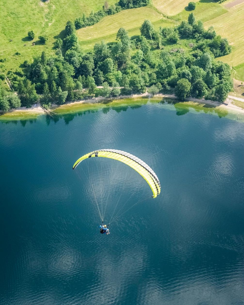 Tandem paragliders from Kumulus Paragliding above Lake Bohinj in Slovenia