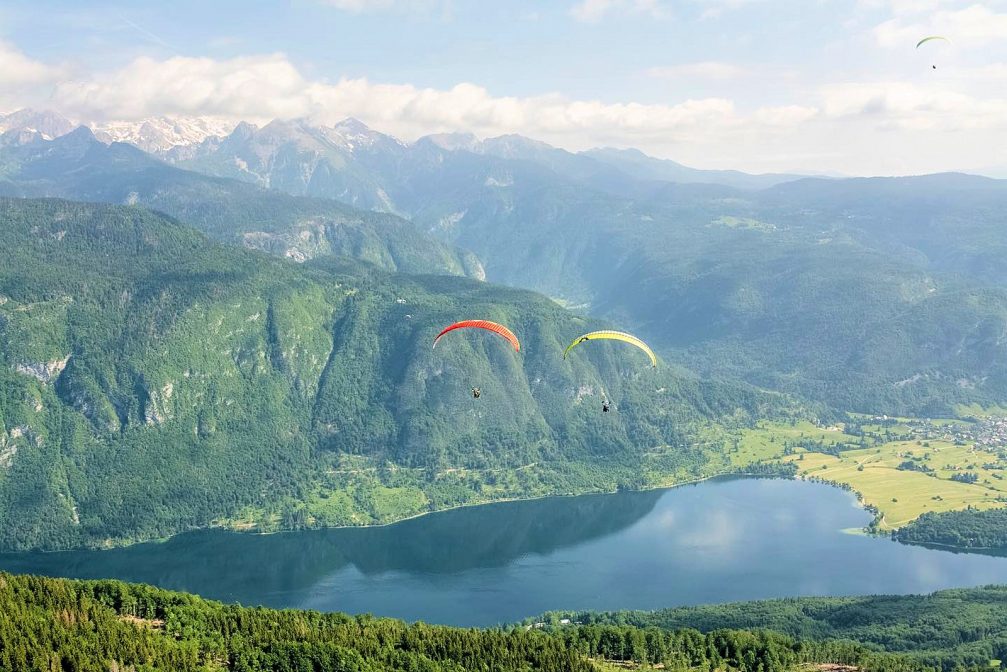 A couple of paragliders above Lake Bohinj as seen from the air