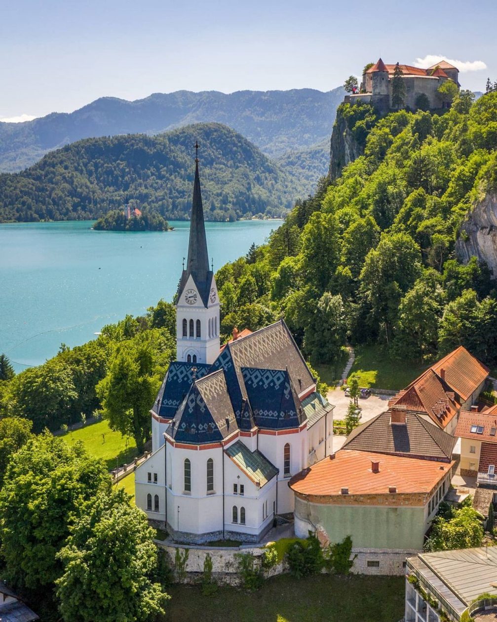 Aerial drone view of Lake Bled with its St. Martins Parish Church and Bled Castle