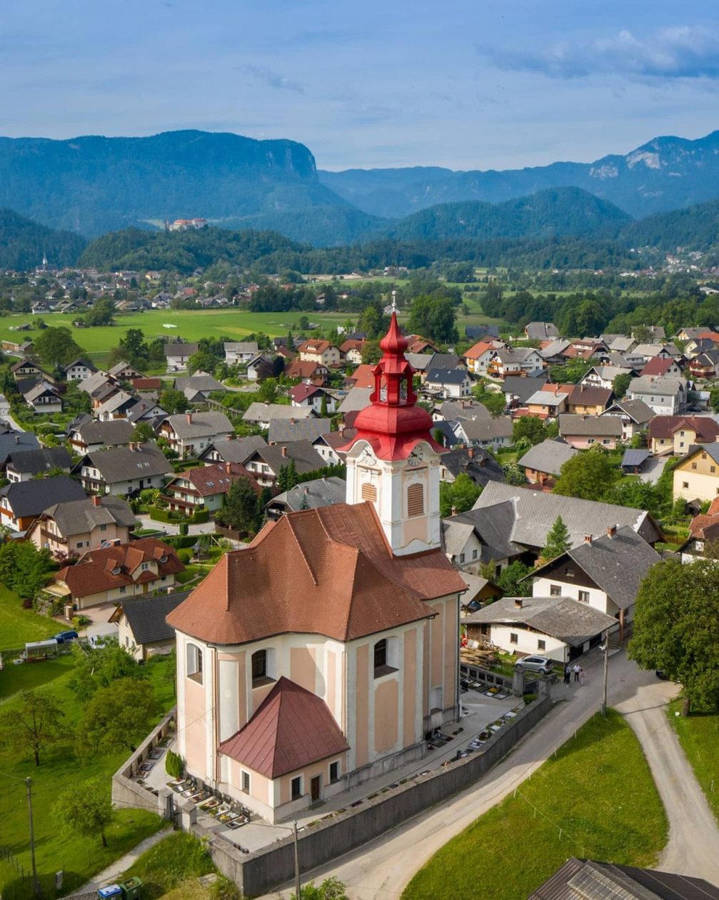 Aerial drone view of Zasip Village with Bled Castle in the background