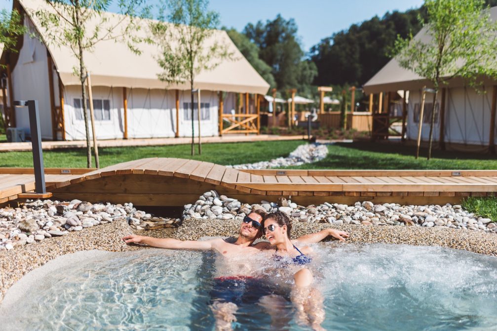 A couple in a jacuzzi in Glamping Olimia Adria Village at Terme Olimia in Podcetrtek 