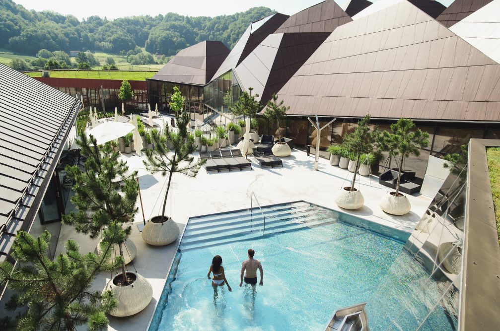 Aerial view of an outdoor pool at Wellness Orhidelia thermal spa in Terme Olimia in Podcetrtek