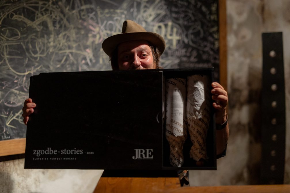 David Vracko of Restaurant Mak holding wine bottles